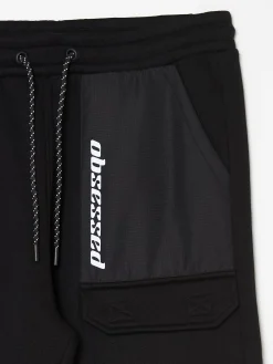 Cropp Spodnie*Czarne dresowe joggery z efektem reflective